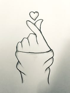 a drawing of a hand holding a heart