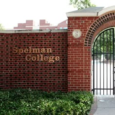 a brick wall with the words bohemian college written on it and a gate in front