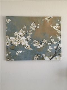 a painting hanging on the wall in a living room next to a dining room table