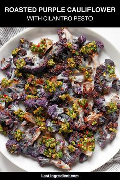 roasted purple cauliflower with cilantro pesto on a white platter