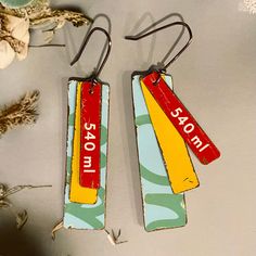 two wooden tags with words on them hanging from hooks