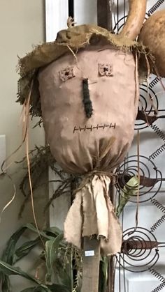 a stuffed animal head hanging from the side of a wall next to a planter