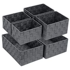 four gray baskets stacked on top of each other