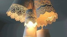 a lamp that is on top of a table with doily and lights attached to it