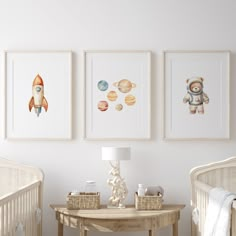 there are three pictures hanging on the wall in this baby's room, each with an astronaut theme