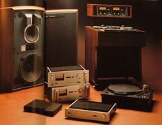 an open book with speakers and other electronic equipment