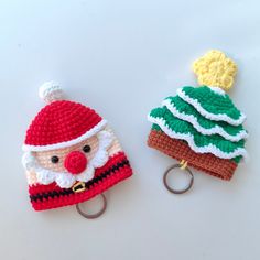 two crocheted christmas hats with key chains