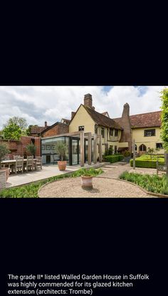 an image of a house that is in the middle of some grass and gravel area