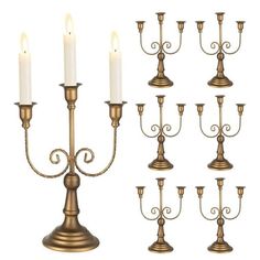 a set of twelve brass candle holders with white candles