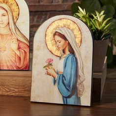 Description: With the wonderfully carved Madonna Of The Rose Arched Wood Plaque, you can embrace the Blessed Virgin Mary's spiritual presence and grace. This plaque, made of high-quality wood, serves as a timeless and reverent reminder of he Blessed Virgin Mary's deep faith and significance.This plaque, which is suitable for a variety of venues such as houses, chapels, or religious schools, adds elegance and spirituality to any place. Catholic Decor, Mama Mary, Blessed Virgin, Blessed Virgin Mary, Catholic Art, Blessed Mother, Mother Mary, Catholic Faith, Religious Gifts