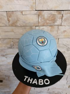 a cake that is shaped like a soccer ball and has the words thabo on it