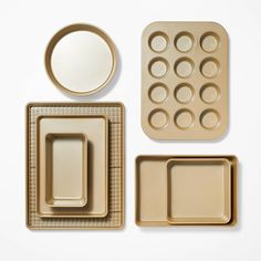 an assortment of food items on a white surface, including trays and muffin tins