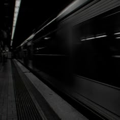 a black and white photo of a train at night