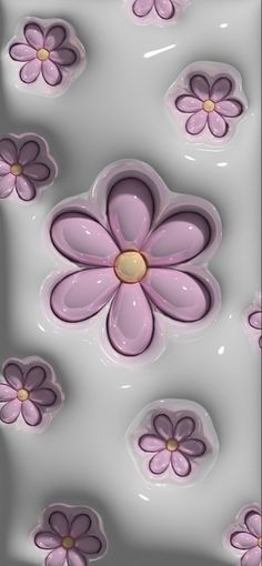 some pink and purple flowers on a gray background with gold centers in the center, as well as white petals