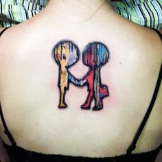 the back of a woman's shoulder with an image of two people holding hands