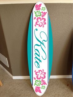 a surfboard with the word love painted on it is leaning against a wall in a room