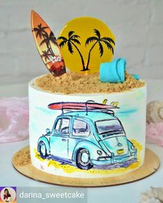 there is a cake decorated with a surfboard and car on the beach as well as other decorations