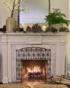 a fireplace with candles and pine cones on top