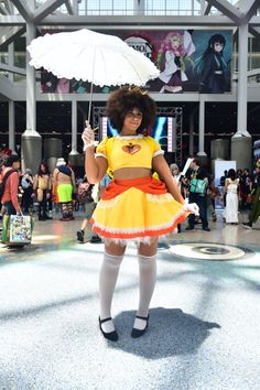 a woman in a costume holding an umbrella