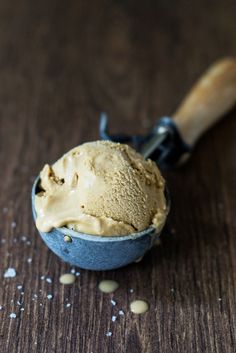 a scoop of ice cream sitting on top of a wooden table