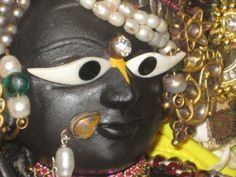 a close up of a mask with pearls on it's face and eyes,