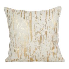 a gold and white pillow with an abstract design on the front, featuring metallic foil