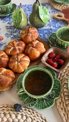 a table topped with plates and bowls filled with pastries on top of each other