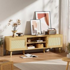 a living room scene with focus on the sideboard and shelf that has pictures on it