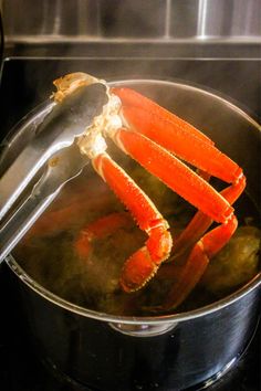 a crab is cooking in a pot on the stove