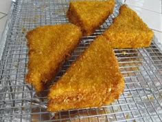 four pieces of fried food on a cooling rack