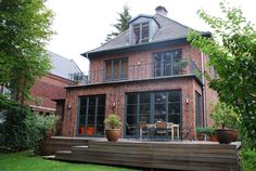 a large brick house with an outdoor deck