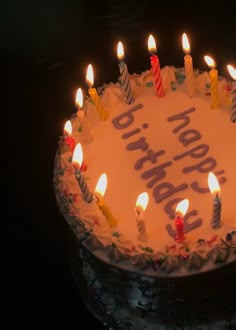 a birthday cake with lit candles on it