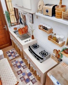 a stove top oven sitting inside of a kitchen next to a counter with plates on it