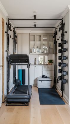 a home gym with treadmills, exercise mat and other equipment in the room