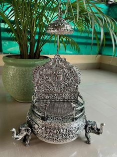 German Silver Hand Engraved Singhasan For Hindu Diety, Antique Oxidized Silver Pooja Items, For Office Temple, House Temple, Housewarming Sihasan with chhattar Swastik chinha on backrest with 3 elephants on bottom 4 Peacocks sitting on railings Measurement: length: 6 Inches  Width: 8 Inches  Height with basket: 12 Inches  Height with chhattar: 19.5 Inches  Chatar of singhasan are foldable and also adjustable according to your size.. Lord idols will brighten up any corner of your home/office on t Traditional Silver Choli With Pallu, Silver Sets With Pallu For Festivals, Traditional Silver Choli For Diwali, Traditional Silver Sets For Navratri, Traditional Sets With Intricate Design For Puja, Silver Ceremonial Sets For Festivals, Silver Cutdana Sets For Festivals, Sharad Poornima, House Temple