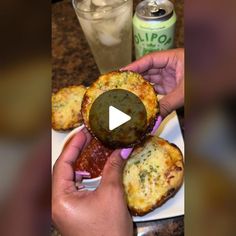 a person is holding up some food on a plate with a soda in the background