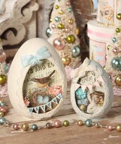 two decorated eggs sitting on top of a table