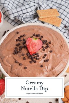 creamy nutella dip in a bowl with chocolate chips and strawberries on the side