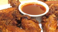 fried chicken wings with dipping sauce on the side