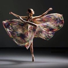 a woman in a long dress is dancing