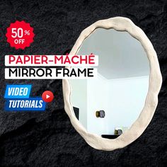 a mirror that is sitting on top of a black surface with the words paper - mache mirror frame