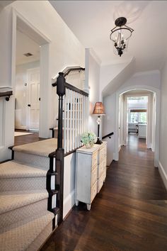 an entry way leading to a living room and dining room with stairs that lead up to the second floor