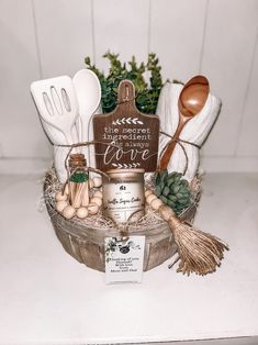 an assortment of kitchen utensils in a basket with a sign that says, i love