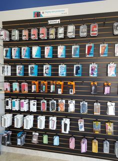 there are many cell phones on display in the store, all lined up against the wall