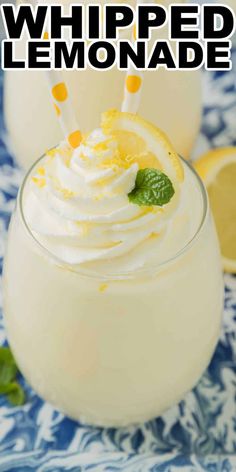 two glasses filled with whipped lemonade on top of a blue and white table cloth