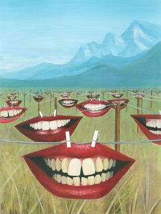 a painting of red lips hanging on clothes pins with mountains in the background