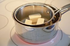 a pot with sugar cubes in it sitting on top of a stove