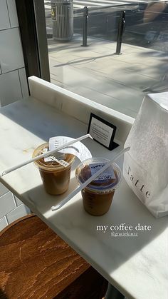 two cups of coffee sitting on top of a table