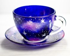 a cup and saucer with stars painted on it