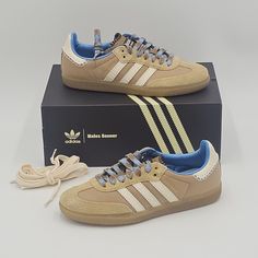 This pair of adidas Samba sneakers, a collaboration with WALES BONNER, is a limited edition release that features a colorful and royal-themed colorblock pattern in desert white, wonder white, and ash blue. Its low-top shoe shaft style and lace-up closure make it a great pick for various occasions such as activewear, casual wear, and workwear. Its lightweight and breathable fabric lining and foam insole material provide comfort and support for walking, school, and dancing. The outsole material is made of rubber and cleat type is also rubber, giving it a good grip and traction. This sneaker is available in US shoe size 8 Mens / 9 womens and UK shoe size 7.5. Its upper material is made of nylon, making it durable and long-lasting. This product is a great addition to any shoe collection and is Wales Bonner, Adidas Samba Sneakers, Top Shoes, Shoe Collection, Breathable Fabric, Casual Wear, Athletic Shoes, Shoes Mens, Work Wear